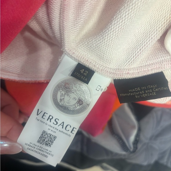 Versace sweater. Orange and pink. It’s like a woman small. - Picture 4 of 5